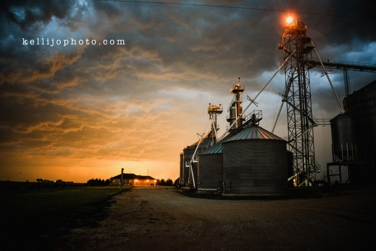 Storm rolling onto farm place in Nebraska, cloudy colorful skies.