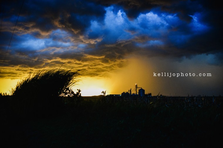 Storm rolling onto farm place in Nebraska, cloudy colorful skies.