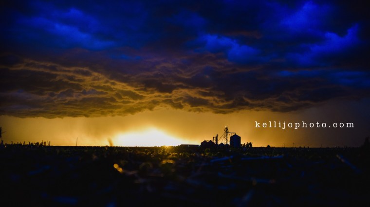 Storm rolling onto farm place in Nebraska, cloudy colorful skies.